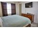 King-size bed, dresser, TV, and sliding door at 6801 Dali Ave # G104, Land O Lakes, FL 34637