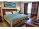 King-size bed, wood furniture, and ensuite bathroom access at 6801 Dali Ave # G104, Land O Lakes, FL 34637