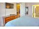 King bed, dresser, TV, and ensuite bathroom at 6801 Dali Ave # G104, Land O Lakes, FL 34637