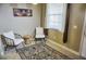 Bright sitting area with two chairs and a small table at 6801 Dali Ave # G104, Land O Lakes, FL 34637