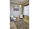 Cozy sitting room with two wicker chairs, a rug, and a window at 6801 Dali Ave # G104, Land O Lakes, FL 34637