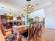 Elegant dining room with a large table, chandelier, and access to the kitchen at 6926 Mccray Dr, Hudson, FL 34667