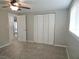 Bedroom with ceiling fan, carpet, and double door closet at 7538 Bougenville Dr, Port Richey, FL 34668