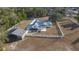 Aerial view showing home, barn, and fenced-in lot at 9331 Elida Rd, Spring Hill, FL 34608