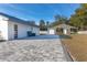 Gray paver patio, detached barn, and fenced backyard at 9331 Elida Rd, Spring Hill, FL 34608