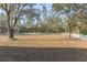 Spacious backyard with white fence and mature trees at 9331 Elida Rd, Spring Hill, FL 34608