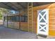 Wooden horse stalls and a ladder in a barn at 9331 Elida Rd, Spring Hill, FL 34608