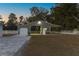 Metal barn with garage door and stalls at 9331 Elida Rd, Spring Hill, FL 34608