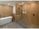 Modern bathroom with walk-in shower and wood wall at 9331 Elida Rd, Spring Hill, FL 34608