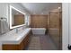 Modern bathroom with double vanity, large tub, and walk-in shower at 9331 Elida Rd, Spring Hill, FL 34608
