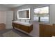 Bathroom with double vanity and modern wood cabinets at 9331 Elida Rd, Spring Hill, FL 34608
