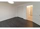 Bright bedroom with dark grey flooring and double doors to hallway at 9331 Elida Rd, Spring Hill, FL 34608
