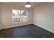 Spacious bedroom with dark grey flooring and a window at 9331 Elida Rd, Spring Hill, FL 34608