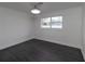 Bright bedroom with dark grey flooring and a window offering a view at 9331 Elida Rd, Spring Hill, FL 34608