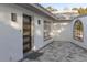 Modern dark brown front door, gray paver walkway, and white stucco exterior at 9331 Elida Rd, Spring Hill, FL 34608