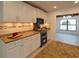 Modern kitchen with granite countertops and stainless steel appliances at 9331 Elida Rd, Spring Hill, FL 34608
