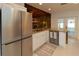 L-shaped kitchen with stainless steel appliances and white cabinets at 9331 Elida Rd, Spring Hill, FL 34608