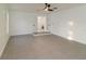 Bright living room with grey tile floors and French doors at 9331 Elida Rd, Spring Hill, FL 34608