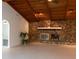 Living room with stone fireplace and wood beamed ceiling at 9331 Elida Rd, Spring Hill, FL 34608