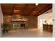Living room with stone fireplace and wood beamed ceiling at 9331 Elida Rd, Spring Hill, FL 34608