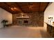 Living room with stone fireplace and wood beamed ceiling at 9331 Elida Rd, Spring Hill, FL 34608