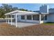 Relaxing patio with pergola, seating area, and adjacent to the house at 9331 Elida Rd, Spring Hill, FL 34608