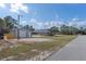 Exterior view of a property featuring a detached shed with a roll-up door on a spacious lot at 11160 Gyrafalcon Ave, Weeki Wachee, FL 34613