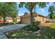 Tan house exterior with a two-car garage and well-maintained landscaping at 11602 Bathgate Ct, New Port Richey, FL 34654