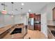 Open kitchen featuring granite countertops, a stainless steel fridge, and ample counter space at 11602 Bathgate Ct, New Port Richey, FL 34654