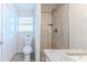 Modern bathroom featuring a tiled walk-in shower, granite countertop, and sleek fixtures at 13531 Allyn Dr, Hudson, FL 34667