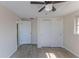 Bedroom with wood-look tile floor, ceiling fan, and neutral paint at 13531 Allyn Dr, Hudson, FL 34667