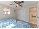 Cozy bedroom showcasing tile flooring, ceiling fan and closet for ample storage at 13531 Allyn Dr, Hudson, FL 34667