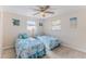 Bright bedroom with ceiling fan, two twin beds and tile floors at 13531 Allyn Dr, Hudson, FL 34667