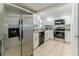 Modern kitchen with white cabinetry, stainless steel appliances, and granite countertops at 13531 Allyn Dr, Hudson, FL 34667