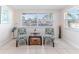 Bright and cozy sitting area with canal view, chairs, and tile flooring at 13531 Allyn Dr, Hudson, FL 34667