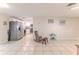 Spacious living area with tile floors leading into the modern kitchen with stainless steel appliances at 13531 Allyn Dr, Hudson, FL 34667