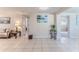 Open-concept living room with tile floors and a glimpse into the adjacent bedrooms at 13531 Allyn Dr, Hudson, FL 34667