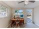 Home office area with natural light, view of the neighborhood, and wood-look tile floors at 13531 Allyn Dr, Hudson, FL 34667