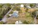 An aerial view of the home, showcasing the backyard, shed, and the adjacent property at 14034 Water Tower Dr, Hudson, FL 34667