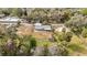 A serene aerial view reveals the home nestled in a peaceful, tree-lined neighborhood at 14034 Water Tower Dr, Hudson, FL 34667