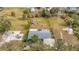 Aerial shot of the home, showcasing the spacious backyard, mature trees and detached shed at 14034 Water Tower Dr, Hudson, FL 34667