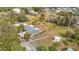 An aerial view of the home with fenced yard, landscaping and carport at 14034 Water Tower Dr, Hudson, FL 34667