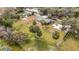 Expansive property featuring a single-Gathering home, lush greenery, and mature palm trees at 14034 Water Tower Dr, Hudson, FL 34667