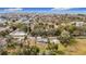 An aerial view shows a charming home nestled among mature trees, in a neighborhood close to the ocean at 14034 Water Tower Dr, Hudson, FL 34667