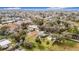 Scenic aerial perspective of a home nestled among lush trees in a quiet neighborhood setting at 14034 Water Tower Dr, Hudson, FL 34667