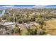An aerial view of a home in a wooded neighborhood, close to the water, with mature trees and lush surroundings at 14034 Water Tower Dr, Hudson, FL 34667