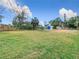 Large backyard featuring lush green grass and perimeter fencing at 14034 Water Tower Dr, Hudson, FL 34667