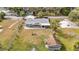 An aerial view of a home with a fire pit, shed, and a cozy outdoor space for entertaining guests at 14034 Water Tower Dr, Hudson, FL 34667