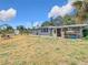 Back of house showing yard with storage in back at 14034 Water Tower Dr, Hudson, FL 34667