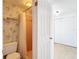 Full bathroom with salmon pink tile shower and unique wall paper with white tile flooring at 14034 Water Tower Dr, Hudson, FL 34667